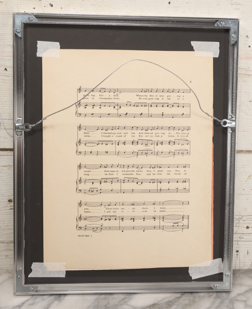 Lot 002 - Antique "At The Devil's Ball" Sheet Music By Irving Berlin With Mephisto Devil Character And Dancing Devils On Cover, Published By Waterson, Berlin, & Snyder Co., New York, New York, Cover Art By Edward H. Pfeiffer, Framed, 13-3/4" x 17-1/4"