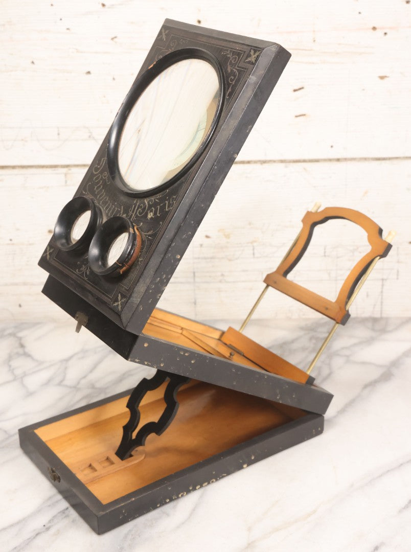 Lot 005 - Antique Black Lacquered Wooden Graphoscope Folding Table Top Stereo Card And Photograph Viewer "Souvenir De Paris", Note Center Lens Has Chip, 6-7/8" x 10-3/4"