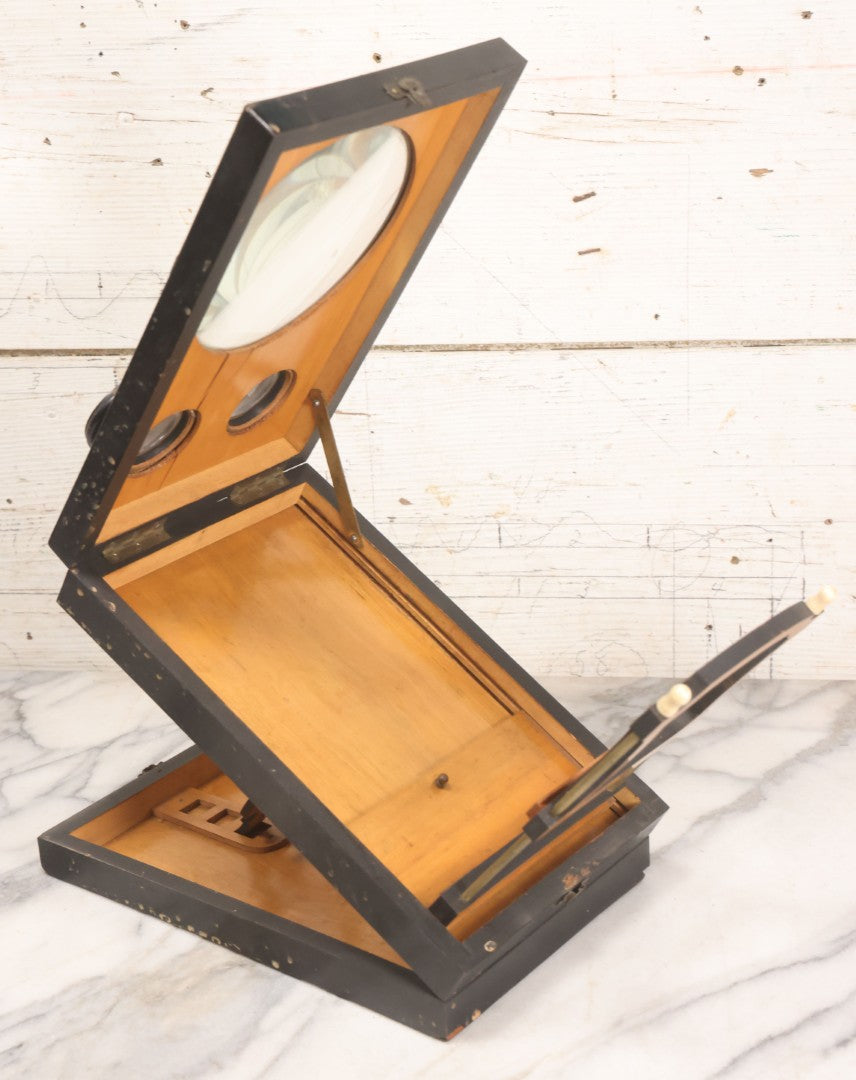 Lot 005 - Antique Black Lacquered Wooden Graphoscope Folding Table Top Stereo Card And Photograph Viewer "Souvenir De Paris", Note Center Lens Has Chip, 6-7/8" x 10-3/4"