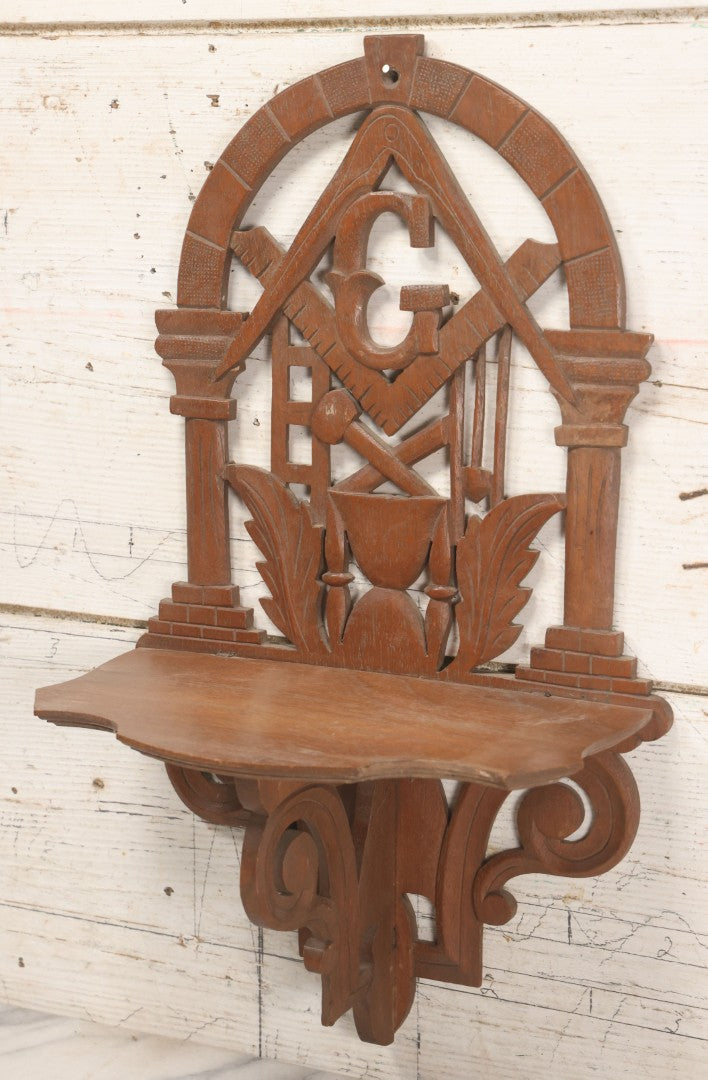 Lot 010 - Vintage Carved Wooden Masonic Folding Wall Shelf With Square And Compass, Columns, Arch, And Acanthus Leaf Motifs, 11-1/4" x 19"
