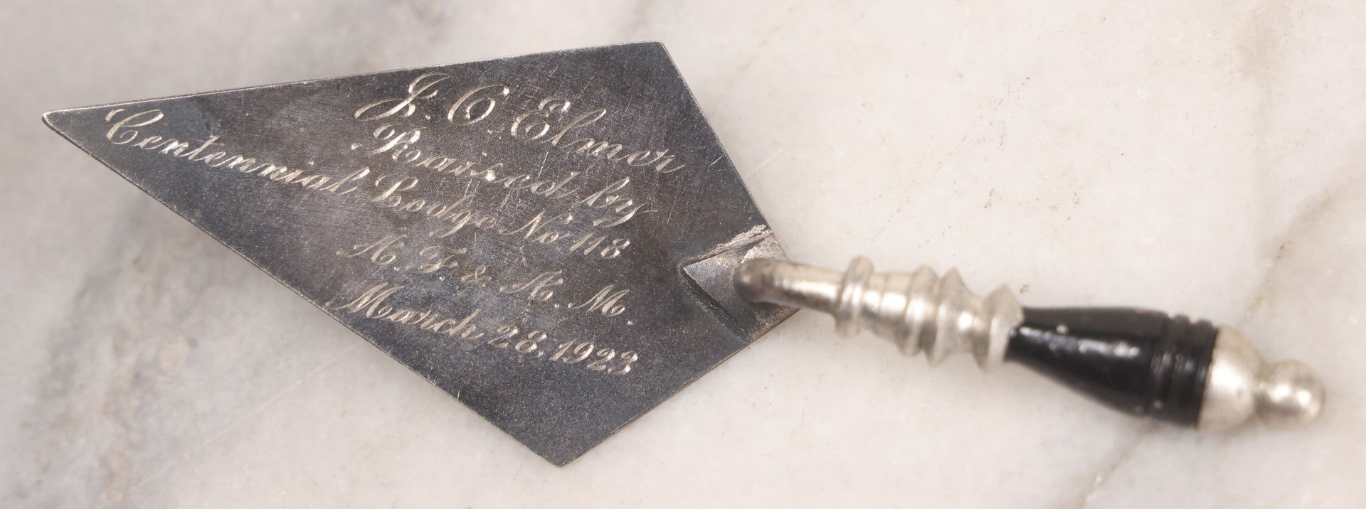 Lot 014 - Antique Miniature Masonic Commemorative Trowel With Metal Blade And Black Lacquered Wooden Handle, "J.C. Elmer Raised By Centennial Lodge No. 118 A.F & A.M. March 28, 1923," 4-1/2" W