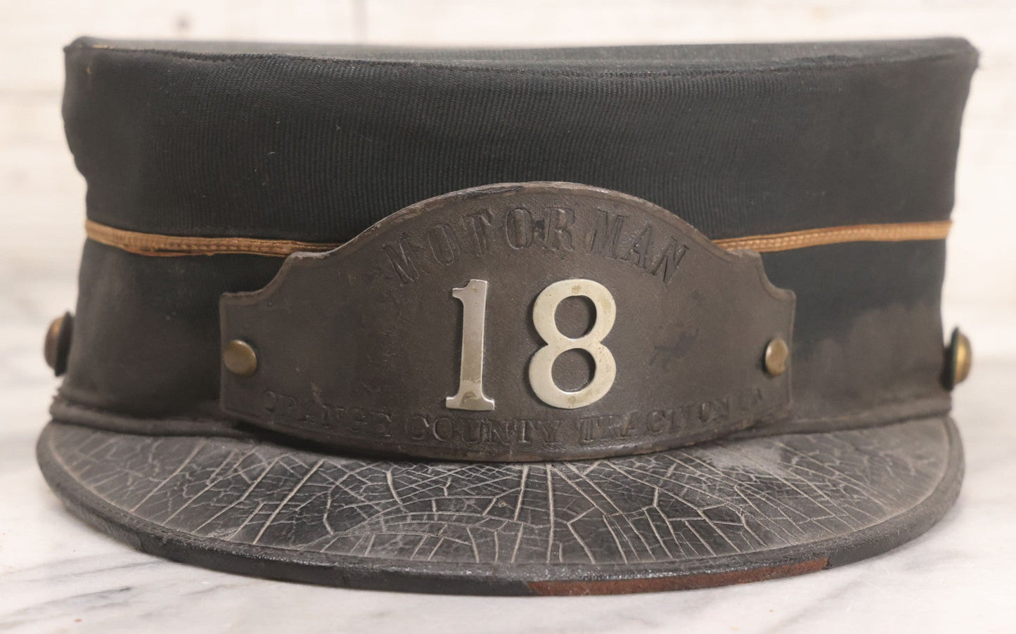 Lot 027 - Antique Orange County Traction Company Trolley Railroad Motorman Hat Number 18 With Leather Badge, Metal Numbers, And Brass Eagle Buttons, Newburgh, New York, Circa Early 20th Century