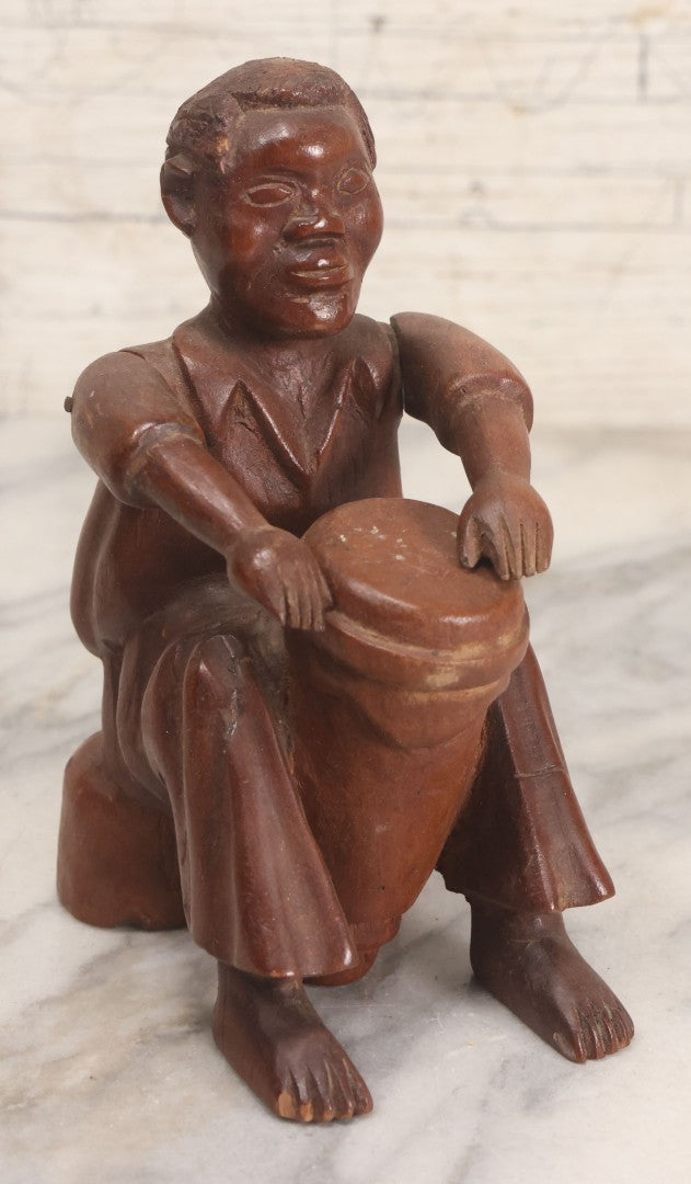 Lot 029 - Vintage Folk Art Carved Wood Figure With Posable Arms Depicting A Seated Man With Drum, 6-1/4" H