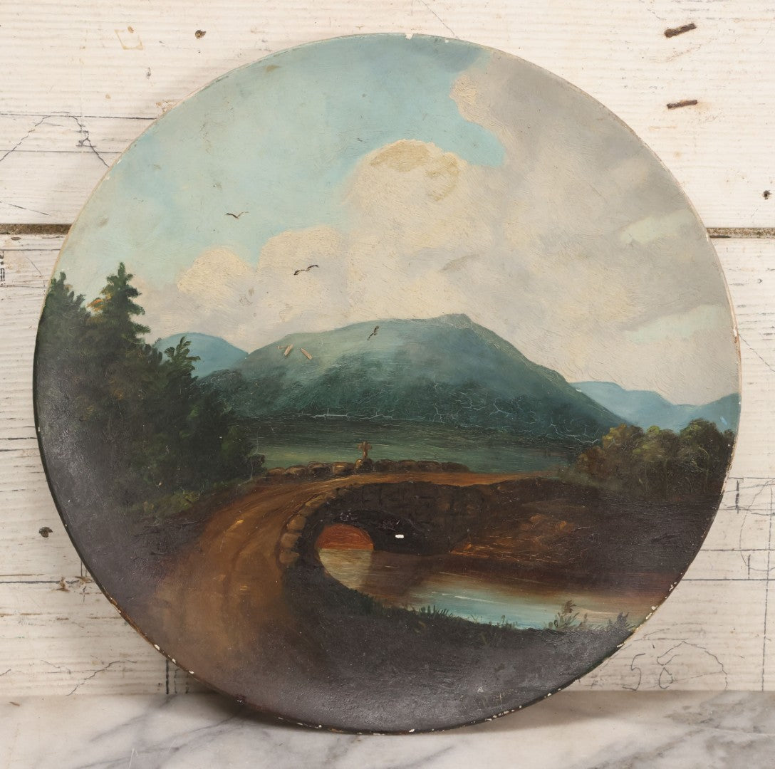 Lot 044 - Antique Folk Art Hand Painted Papier Mache Charger With Stone Bridge, Mountain Lake Landscape, And Cloudy Sky, Circa 1880, 12-1/8" Diameter