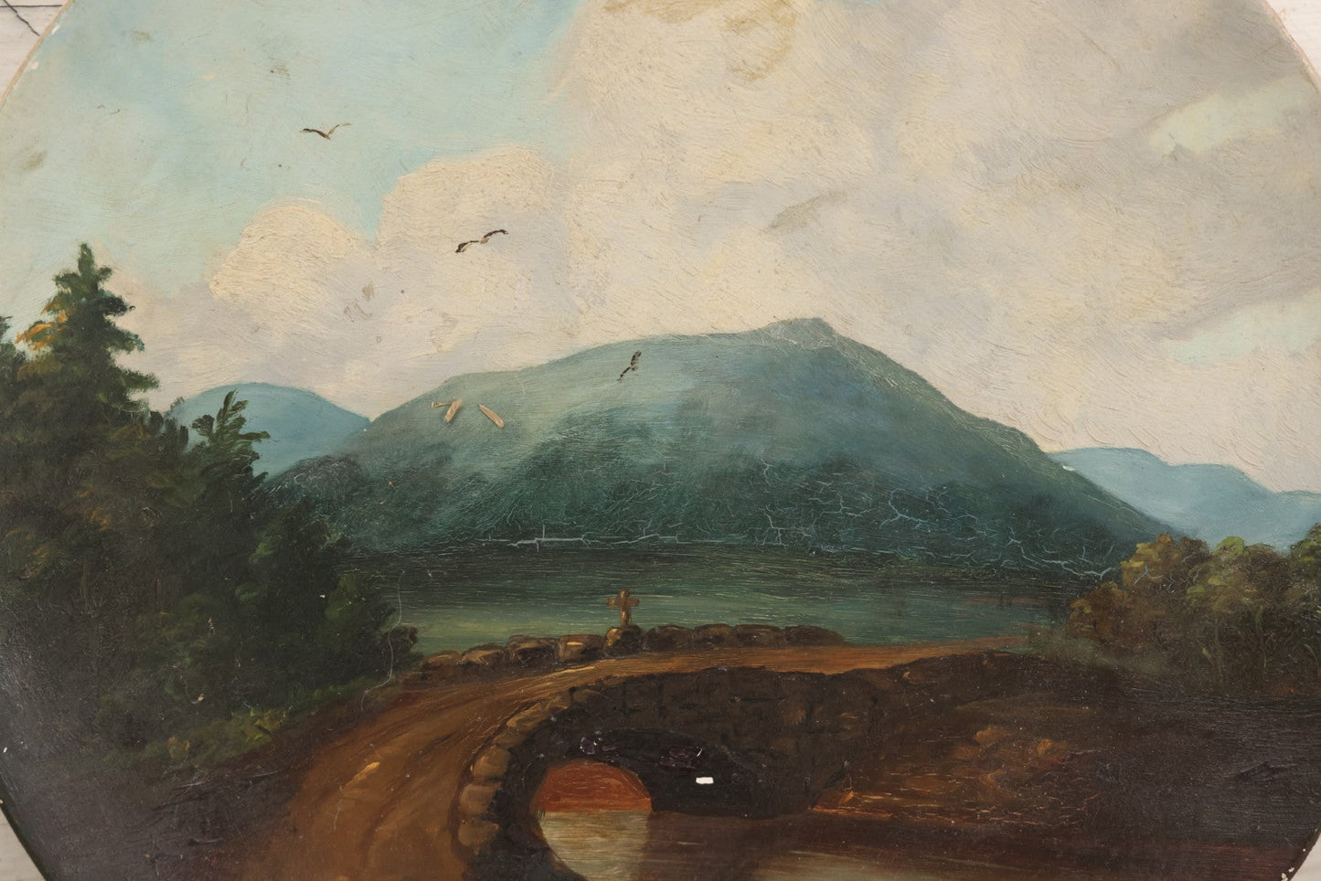 Lot 044 - Antique Folk Art Hand Painted Papier Mache Charger With Stone Bridge, Mountain Lake Landscape, And Cloudy Sky, Circa 1880, 12-1/8" Diameter