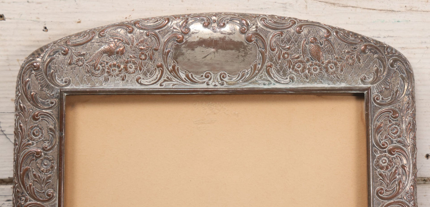 Lot 054 - Antique French Silvered Bronze Picture Frame With Repoussé Floral Scrollwork And Figural Scenes, With Glass, Circa Early 20th Century, 10-3/4" x 13-1/2"