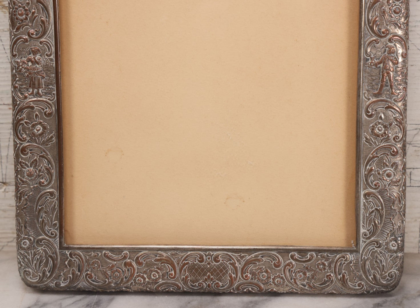 Lot 054 - Antique French Silvered Bronze Picture Frame With Repoussé Floral Scrollwork And Figural Scenes, With Glass, Circa Early 20th Century, 10-3/4" x 13-1/2"