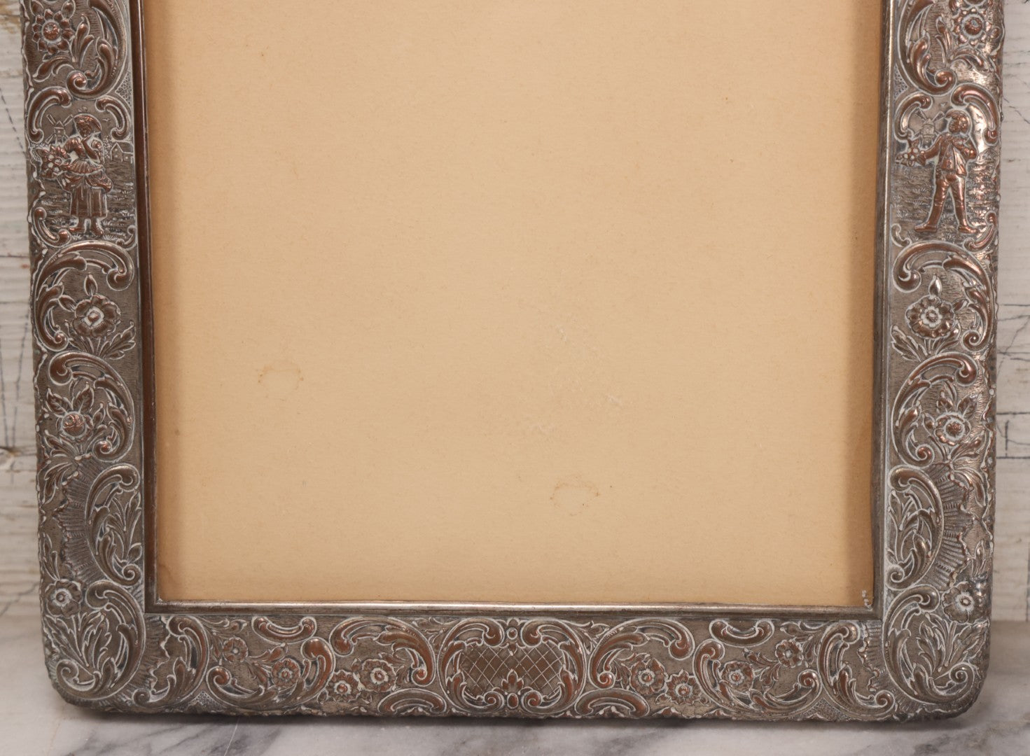 Lot 054 - Antique French Silvered Bronze Picture Frame With Repoussé Floral Scrollwork And Figural Scenes, With Glass, Circa Early 20th Century, 10-3/4" x 13-1/2"