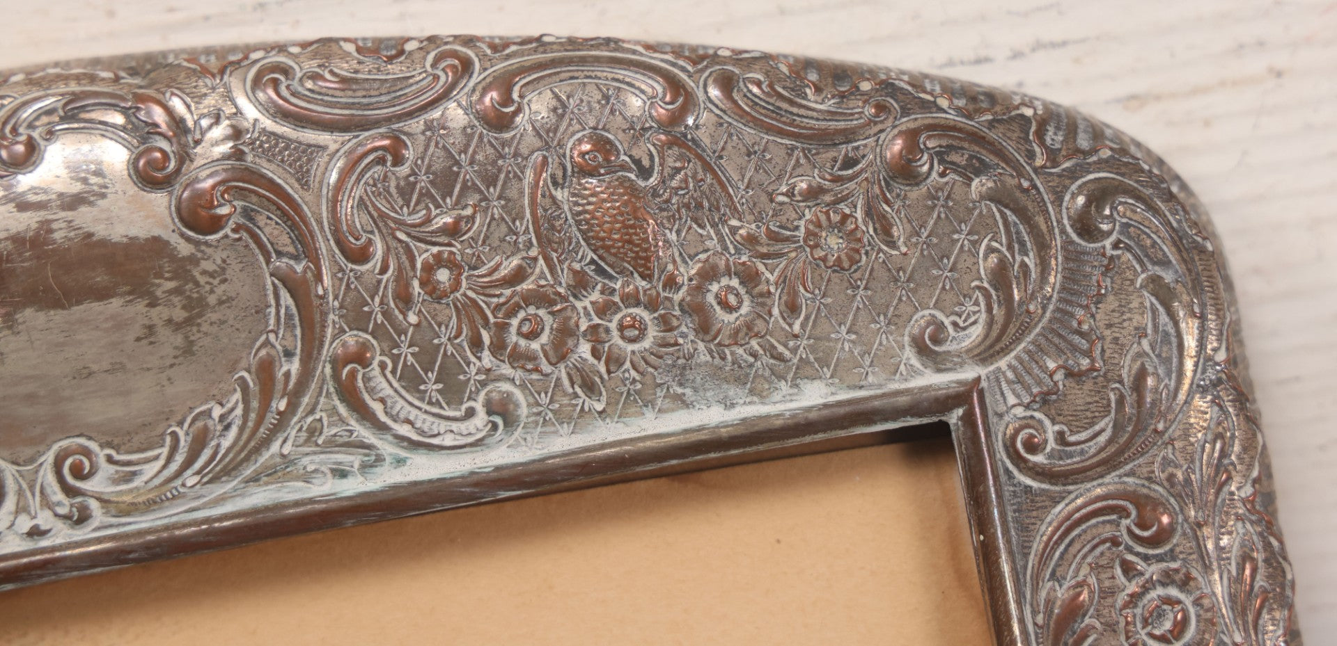 Lot 054 - Antique French Silvered Bronze Picture Frame With Repoussé Floral Scrollwork And Figural Scenes, With Glass, Circa Early 20th Century, 10-3/4" x 13-1/2"