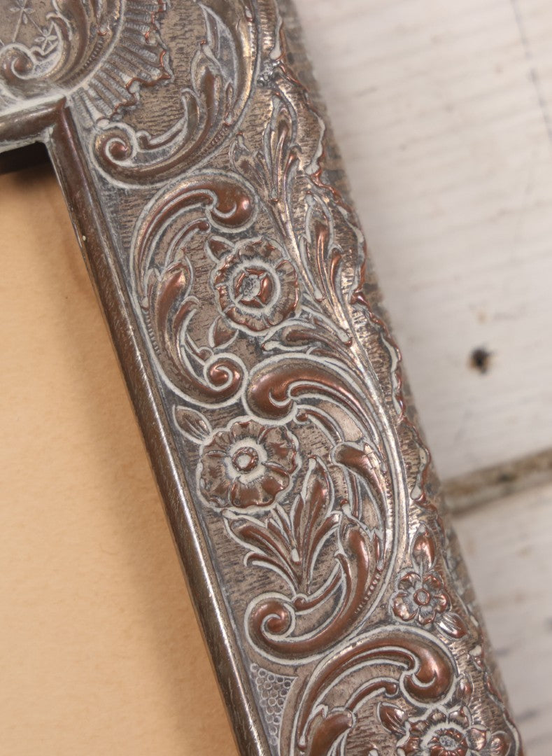 Lot 054 - Antique French Silvered Bronze Picture Frame With Repoussé Floral Scrollwork And Figural Scenes, With Glass, Circa Early 20th Century, 10-3/4" x 13-1/2"