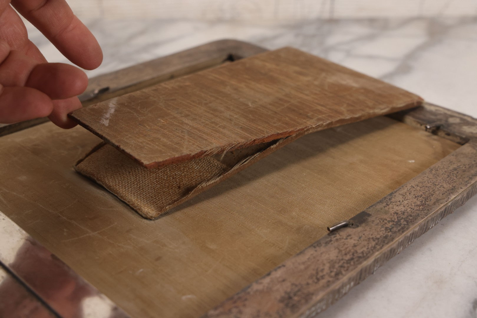 Lot 054 - Antique French Silvered Bronze Picture Frame With Repoussé Floral Scrollwork And Figural Scenes, With Glass, Circa Early 20th Century, 10-3/4" x 13-1/2"