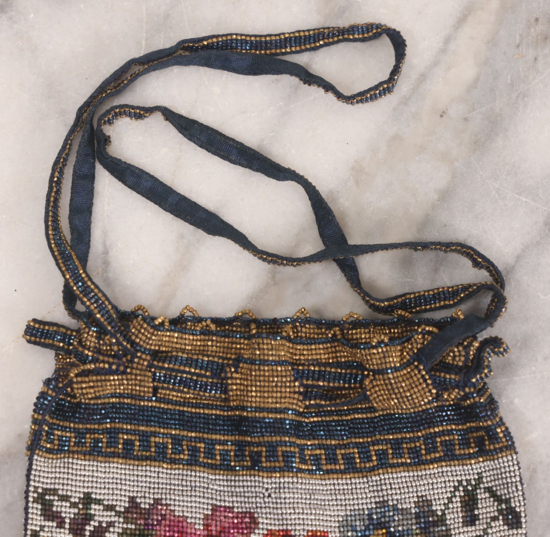 Lot 061 - Antique Beaded Drawstring Purse With Floral Panel, Greek Key Border, And Beaded Fringe, Seed Bead Construction