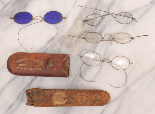 Lot 063 - Grouping Of Four Antique Wire Frame Spectacles Including Blue Lens Spectacles, With Two Partial Leather Cases, Edward E. Dammers, Worcester, Massachusetts