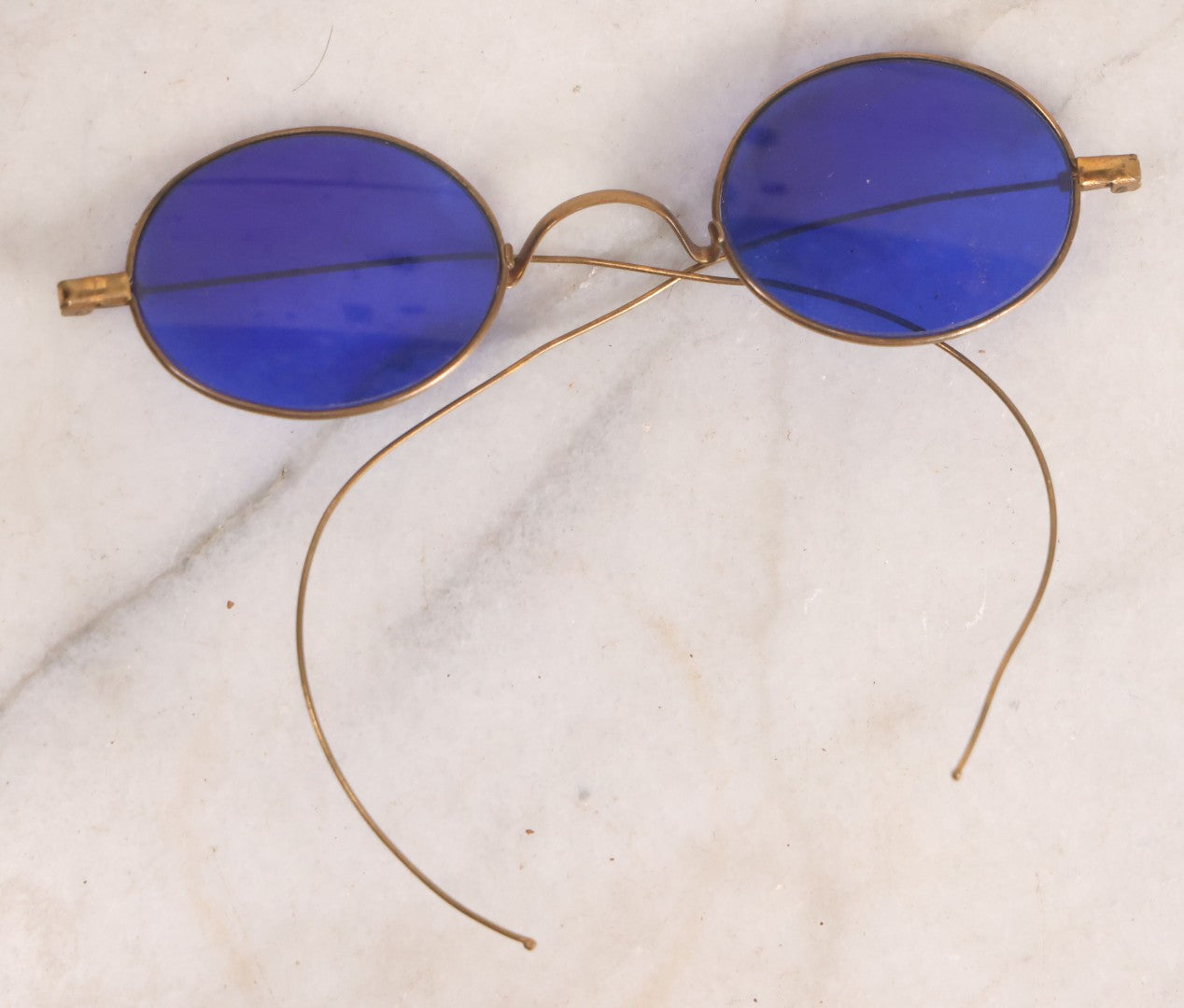 Lot 063 - Grouping Of Four Antique Wire Frame Spectacles Including Blue Lens Spectacles, With Two Partial Leather Cases, Edward E. Dammers, Worcester, Massachusetts