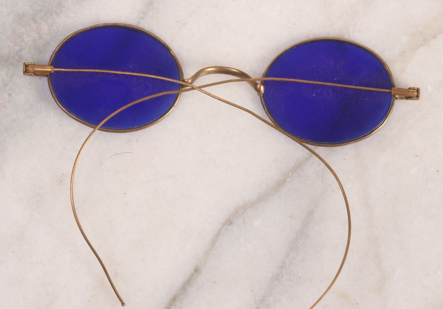 Lot 063 - Grouping Of Four Antique Wire Frame Spectacles Including Blue Lens Spectacles, With Two Partial Leather Cases, Edward E. Dammers, Worcester, Massachusetts