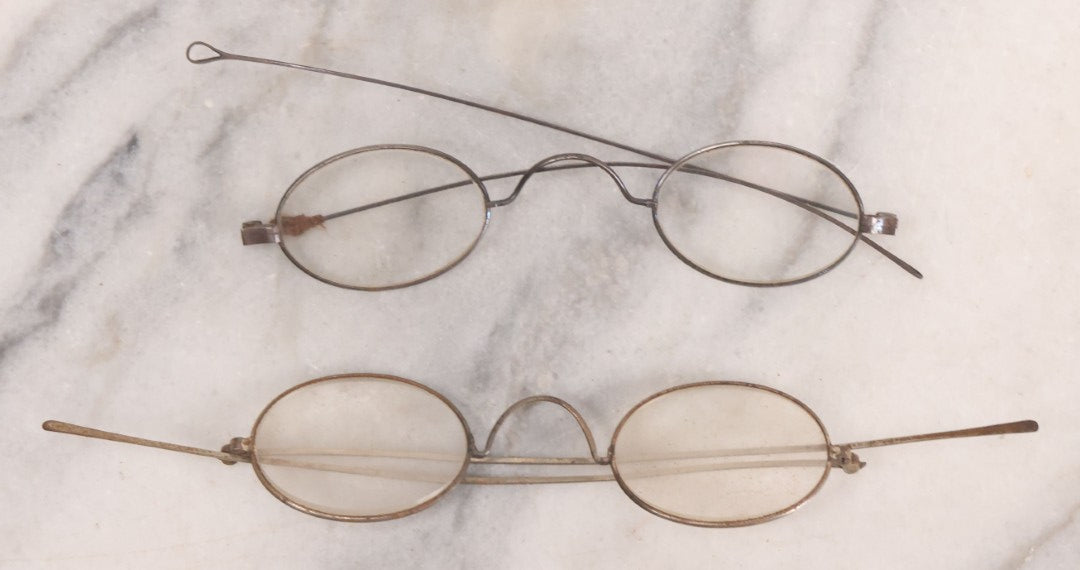 Lot 063 - Grouping Of Four Antique Wire Frame Spectacles Including Blue Lens Spectacles, With Two Partial Leather Cases, Edward E. Dammers, Worcester, Massachusetts