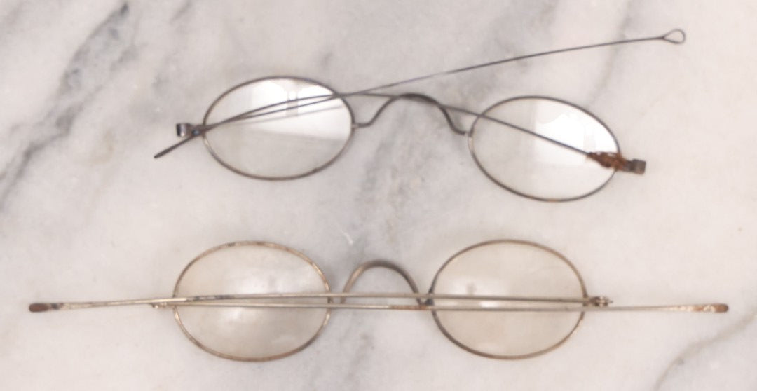 Lot 063 - Grouping Of Four Antique Wire Frame Spectacles Including Blue Lens Spectacles, With Two Partial Leather Cases, Edward E. Dammers, Worcester, Massachusetts