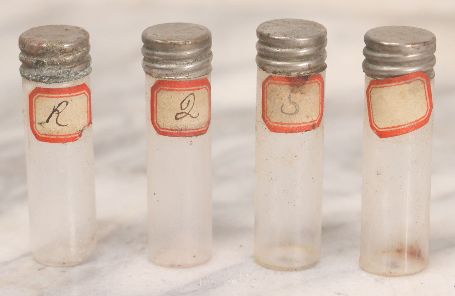 Lot 067 - Antique Pocket Apothecary / Homeopathic Vial Set With Four Glass Vials In Leatherette Case, Metal Screw Caps, Handwritten Labels