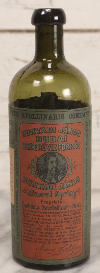 Lot 069 - Antique Hunyadi János Budai Mineral Spring Water Bottle With Paper Label, The Apollinaris Company, Andreas Saxlehner, Budapest, Hungary, 9-1/4" H
