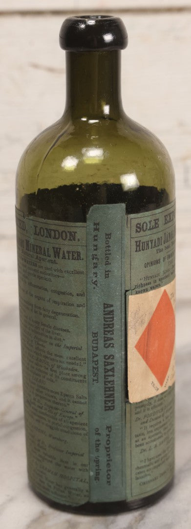 Lot 069 - Antique Hunyadi János Budai Mineral Spring Water Bottle With Paper Label, The Apollinaris Company, Andreas Saxlehner, Budapest, Hungary, 9-1/4" H
