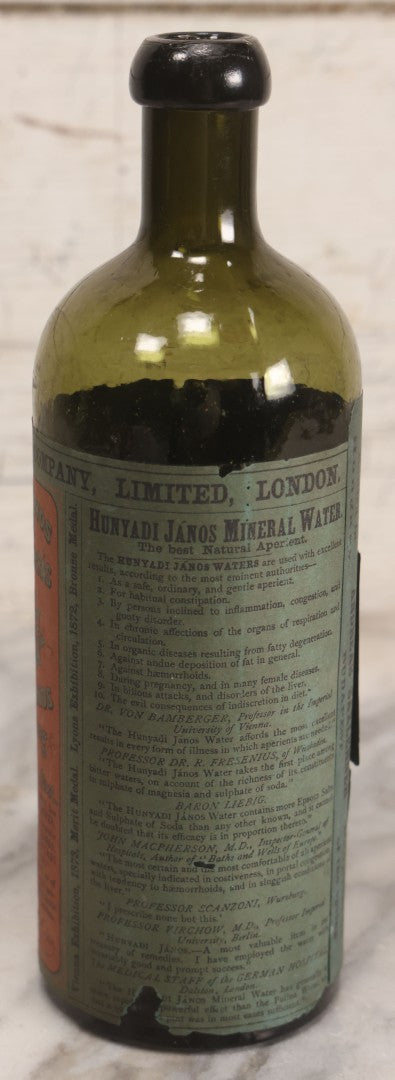 Lot 069 - Antique Hunyadi János Budai Mineral Spring Water Bottle With Paper Label, The Apollinaris Company, Andreas Saxlehner, Budapest, Hungary, 9-1/4" H