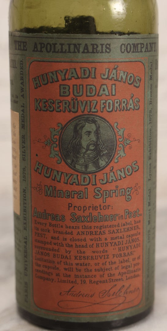 Lot 069 - Antique Hunyadi János Budai Mineral Spring Water Bottle With Paper Label, The Apollinaris Company, Andreas Saxlehner, Budapest, Hungary, 9-1/4" H