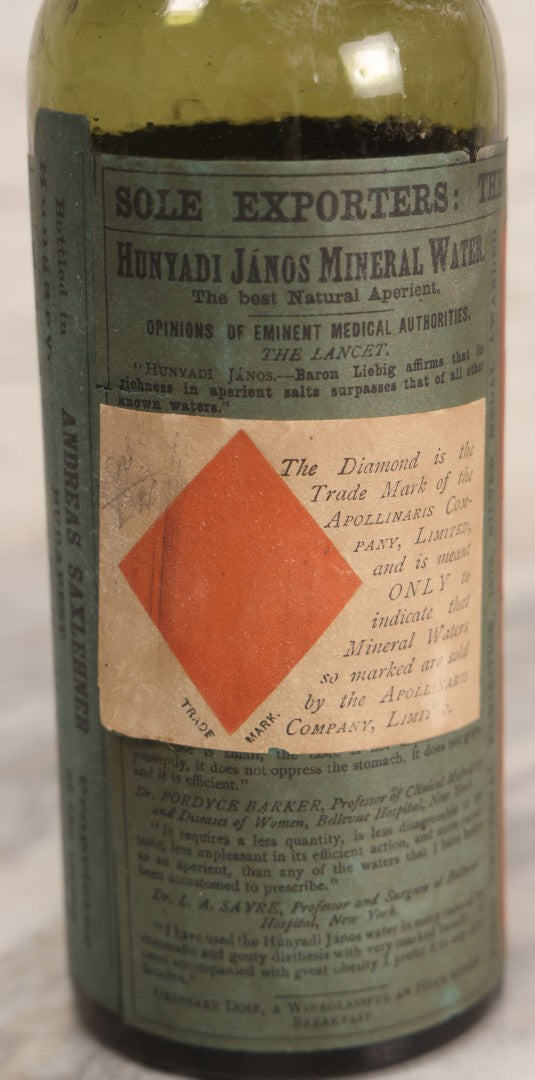 Lot 069 - Antique Hunyadi János Budai Mineral Spring Water Bottle With Paper Label, The Apollinaris Company, Andreas Saxlehner, Budapest, Hungary, 9-1/4" H