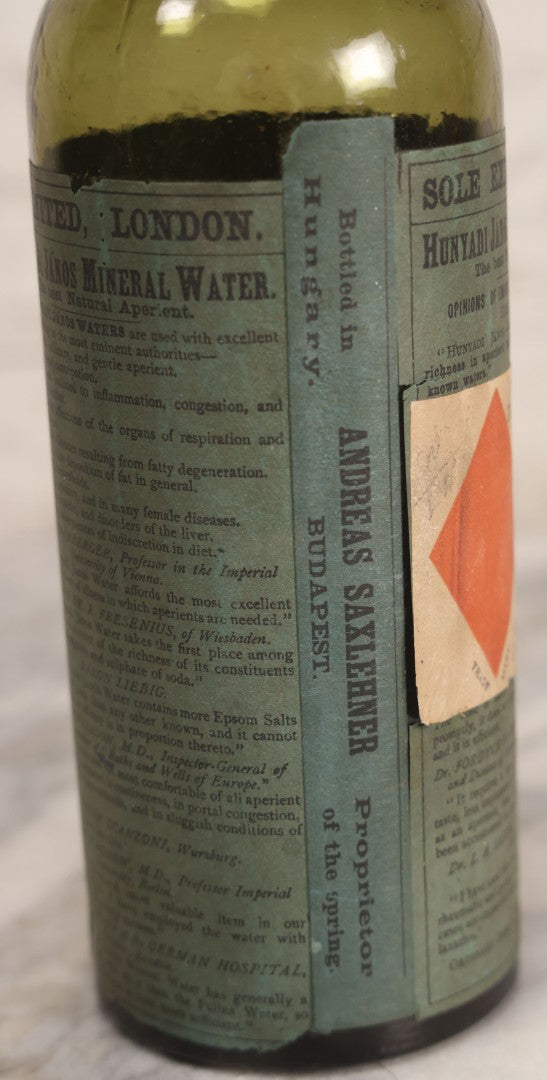 Lot 069 - Antique Hunyadi János Budai Mineral Spring Water Bottle With Paper Label, The Apollinaris Company, Andreas Saxlehner, Budapest, Hungary, 9-1/4" H