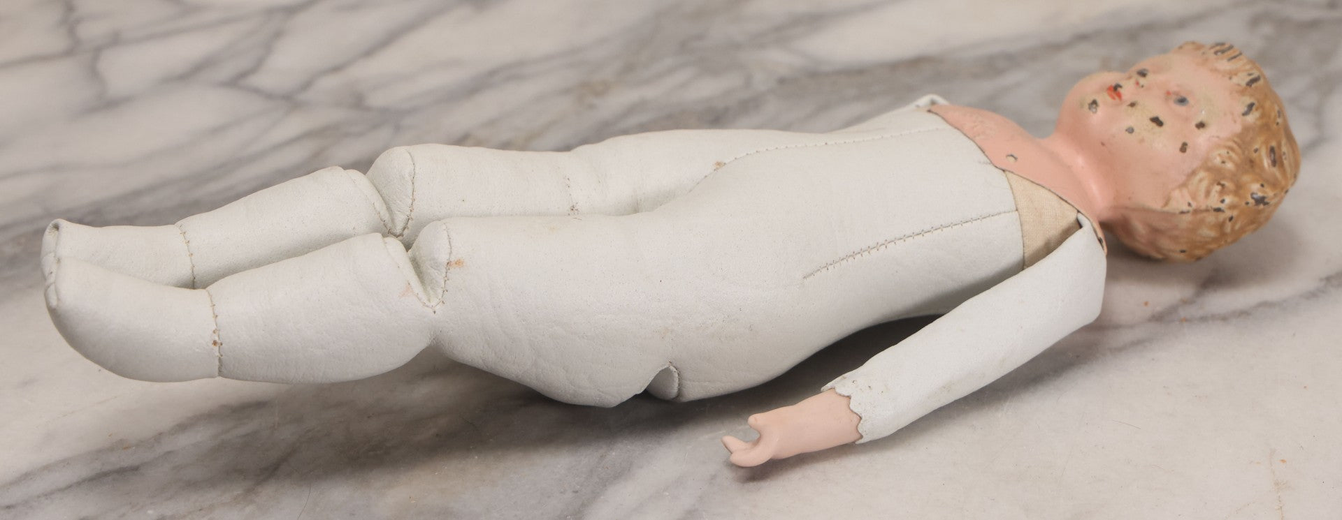 Lot 084 - Antique German Minerva Metal Head Doll With Molded Blonde Hair And Painted Features, Cloth And Leather Body, Circa 1900s-1920s 12" H