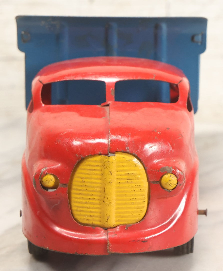Lot 089 - Vintage Blue And Red Pressed Steel Dump Truck, Wyandotte Toys, Circa 1940s With Working Tilting Bed And Yellow Painted Grille, 13" L
