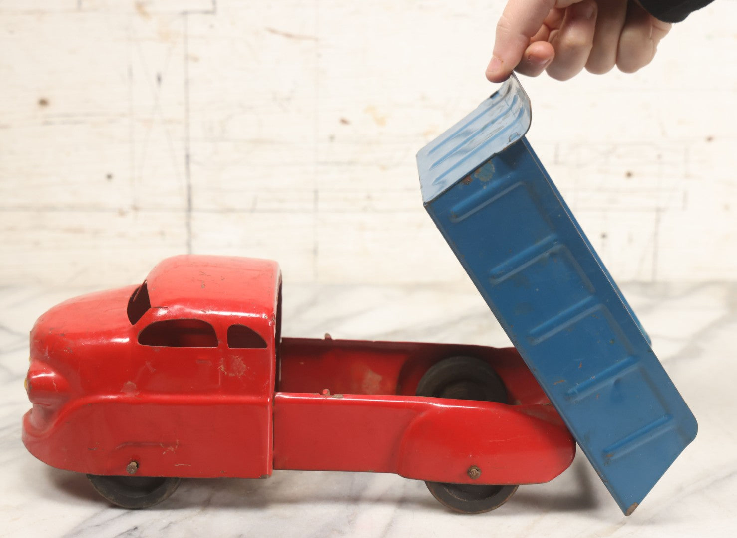 Lot 089 - Vintage Blue And Red Pressed Steel Dump Truck, Wyandotte Toys, Circa 1940s With Working Tilting Bed And Yellow Painted Grille, 13" L