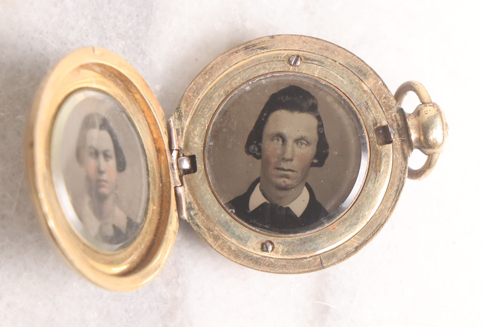 Lot 141 - Antique Gold Toned Locket With Tintype Photographs Of A Young Woman And Man Under Beveled Glass Circles