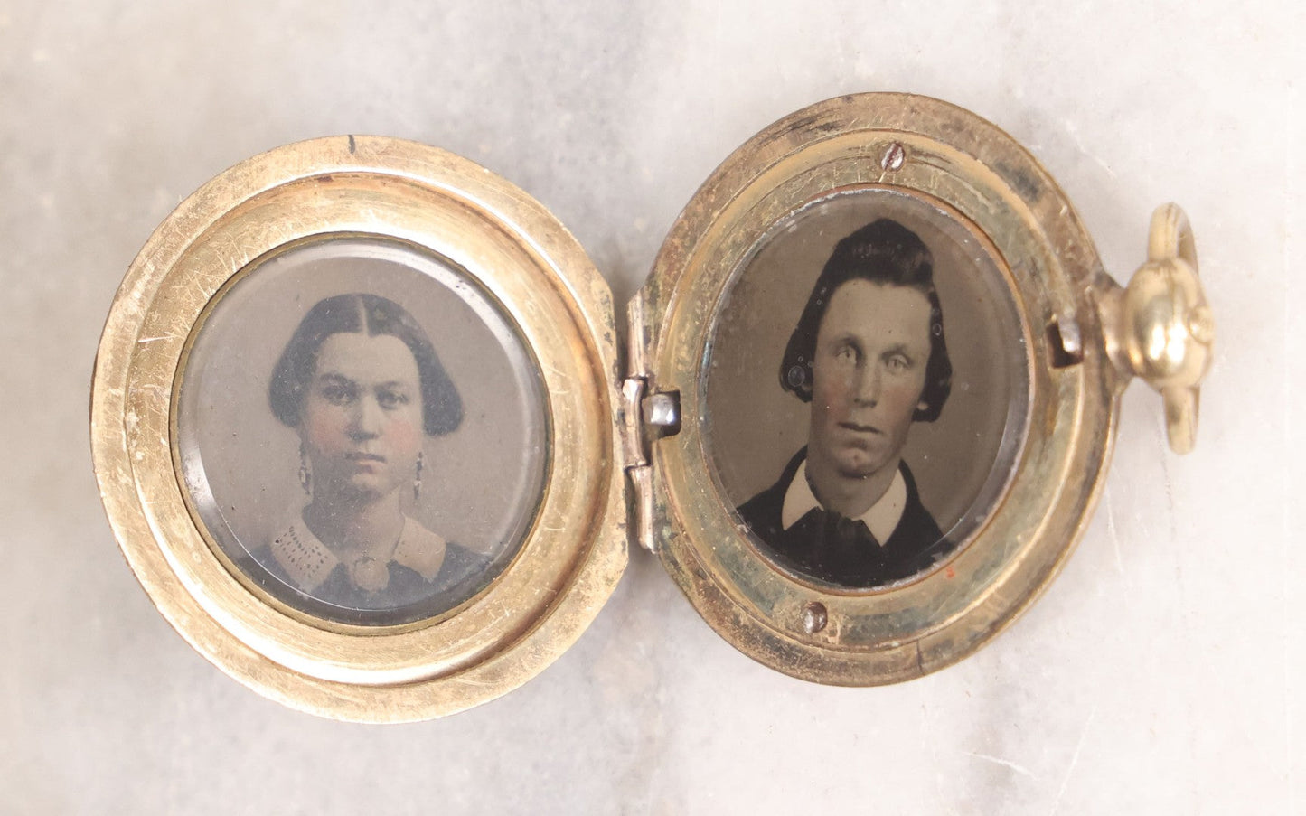 Lot 141 - Antique Gold Toned Locket With Tintype Photographs Of A Young Woman And Man Under Beveled Glass Circles
