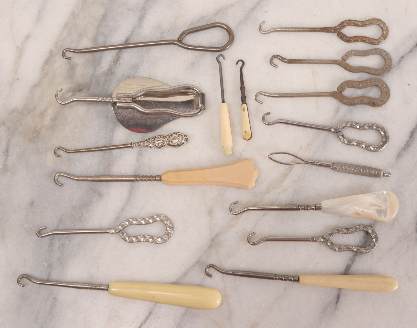 Lot 158 - Grouping Of 16 Antique And Vintage Buttonhooks In Various Materials Including Sterling Silver, Bone, Celluloid, And Mother-Of-Pearl