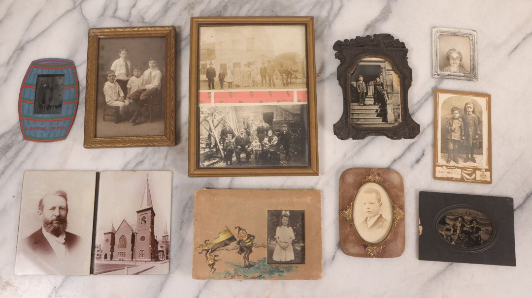 Lot 170 - Grouping Of 10 Antique Photographs In Miscellaneous Frames Including Damaged Thermoplastic Frame, Illustrated Frame With Brownies Characters, Folding Glass Mounted Photo Frame With Pastor And Church, Velvet Frame With C.D.V. Of Child, Tintypes
