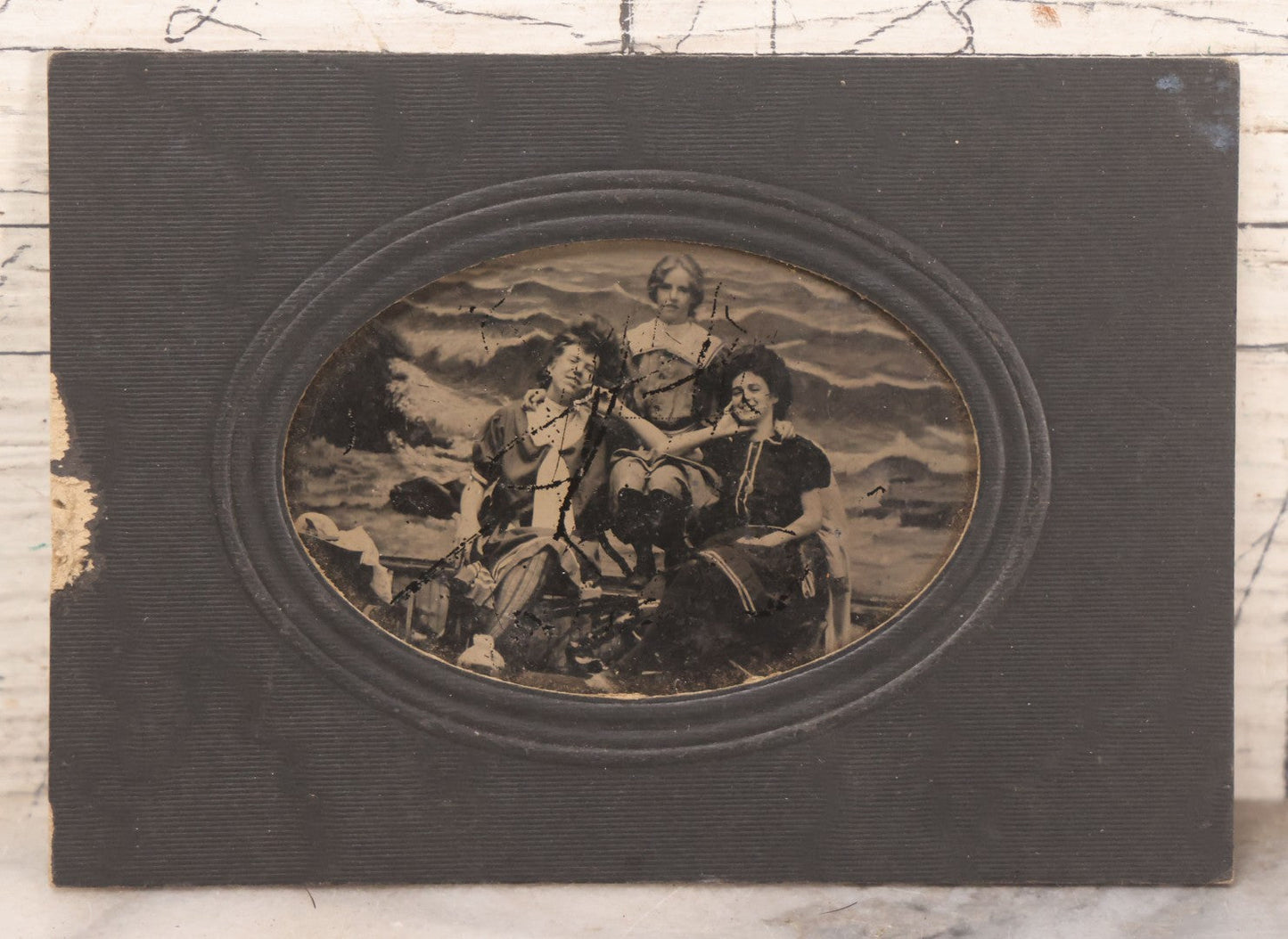 Lot 170 - Grouping Of 10 Antique Photographs In Miscellaneous Frames Including Damaged Thermoplastic Frame, Illustrated Frame With Brownies Characters, Folding Glass Mounted Photo Frame With Pastor And Church, Velvet Frame With C.D.V. Of Child, Tintypes