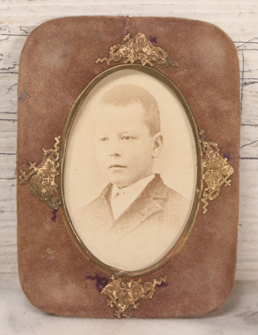 Lot 170 - Grouping Of 10 Antique Photographs In Miscellaneous Frames Including Damaged Thermoplastic Frame, Illustrated Frame With Brownies Characters, Folding Glass Mounted Photo Frame With Pastor And Church, Velvet Frame With C.D.V. Of Child, Tintypes