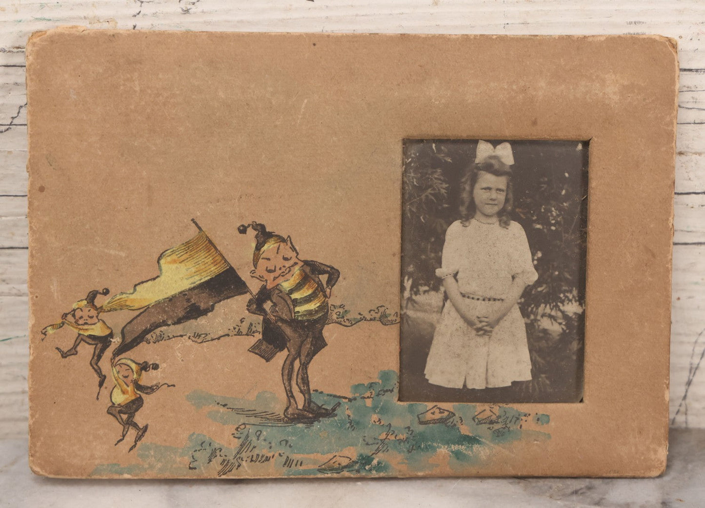 Lot 170 - Grouping Of 10 Antique Photographs In Miscellaneous Frames Including Damaged Thermoplastic Frame, Illustrated Frame With Brownies Characters, Folding Glass Mounted Photo Frame With Pastor And Church, Velvet Frame With C.D.V. Of Child, Tintypes