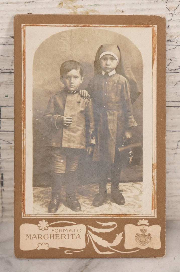 Lot 170 - Grouping Of 10 Antique Photographs In Miscellaneous Frames Including Damaged Thermoplastic Frame, Illustrated Frame With Brownies Characters, Folding Glass Mounted Photo Frame With Pastor And Church, Velvet Frame With C.D.V. Of Child, Tintypes