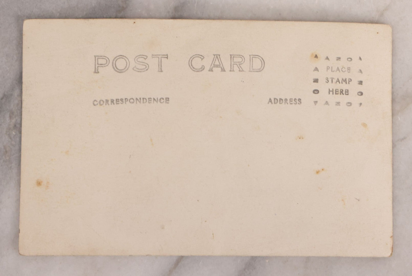 Lot 174 - Antique Real Photo Postcard R.P.P.C. Of Man In Uniform And Cap With Cigarette Before American Flag Backdrop, Circa 1910s