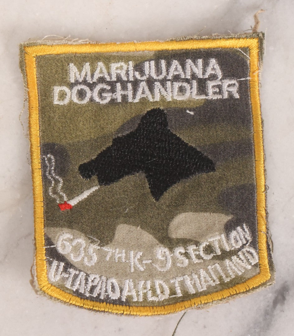 Lot 205 - Grouping Of Six Vintage Vietnam Era Marijuana Doghandler United States Air Force 635th K-9 Section, Thailand Embroidered Patches With Silhouette Of Dog Smoking Joint