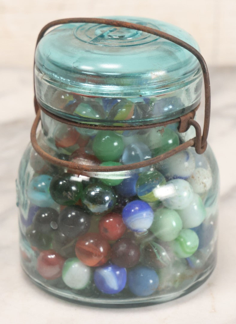 Lot 211 - Vintage Mason Jar Full Of Marbles With Wire Bail Closure