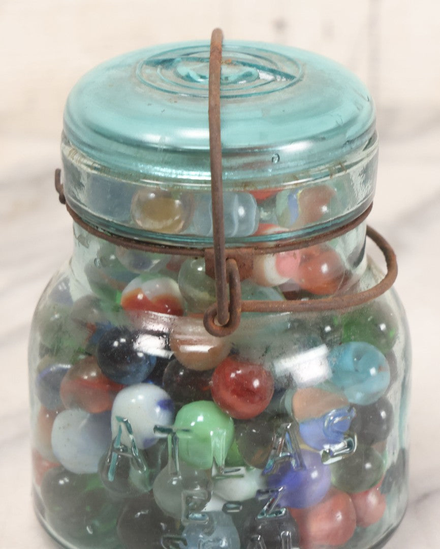 Lot 211 - Vintage Mason Jar Full Of Marbles With Wire Bail Closure