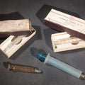 Lot 012 - Grouping Of Four Vintage Glass Medical Syringes Including Two Boxed B-D Yale Hypodermic Syringes By Becton, Dickinson And Company, Rutherford, New Jersey, One Propper Mfg. Co. 10Cc Syringe, And One B-D Yale Luer-Lok Syringe