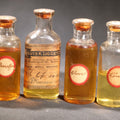 Lot 018 - Grouping Of Six Vintage Glass Flavoring Oil Extract Bottles With Contents Including Anise, Lemon, Lime, Clove, Orange, And Sassafras, 3-1/8" H and 3-1/2" H