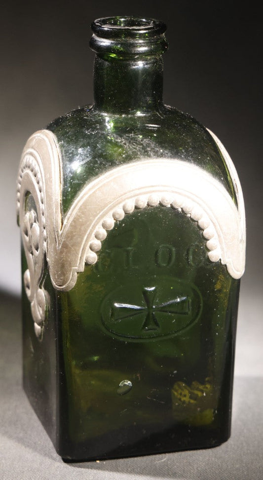 Lot 019 - Vintage Green Glass Flask Bottle Marked "C.L.O.C." With Applied Pewter Decorative Overlay, Beaded Arch With Iron Cross Cartouche On Front And Back, Scrollwork On Sides