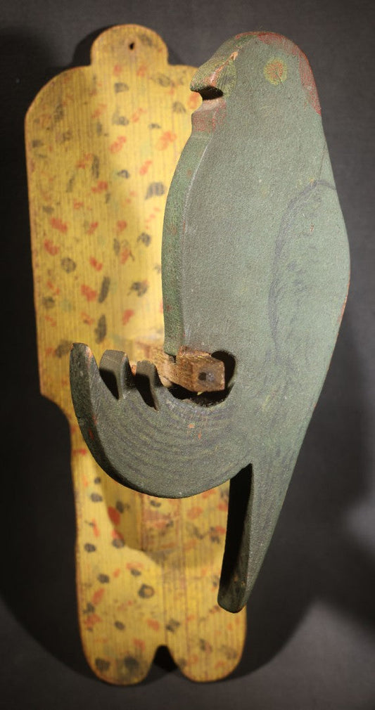 Lot 035 - Antique Folk Art Painted Green Scroll-Cut Wooden Wall-Mounted Parrot On Yellow Spatter-Painted Backboard
