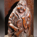 Lot 037 - Antique Folk Art Hand-Carved Wooden Figural Sculpture Of A Laughing Man With A Stein, Leaning On Books, 7" H