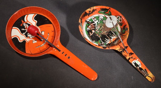 Lot 049 - Pair Of Vintage Halloween Tin Lithograph Paddle Noisemakers, T. Cohn Inc. Jack-O-Lantern J.O.L. And Witch Woman, And U.S. Metal Toy Mfg. Co. Witch, Ghost, Black Cat, And Haunted House