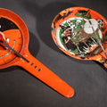 Lot 049 - Pair Of Vintage Halloween Tin Lithograph Paddle Noisemakers, T. Cohn Inc. Jack-O-Lantern J.O.L. And Witch Woman, And U.S. Metal Toy Mfg. Co. Witch, Ghost, Black Cat, And Haunted House